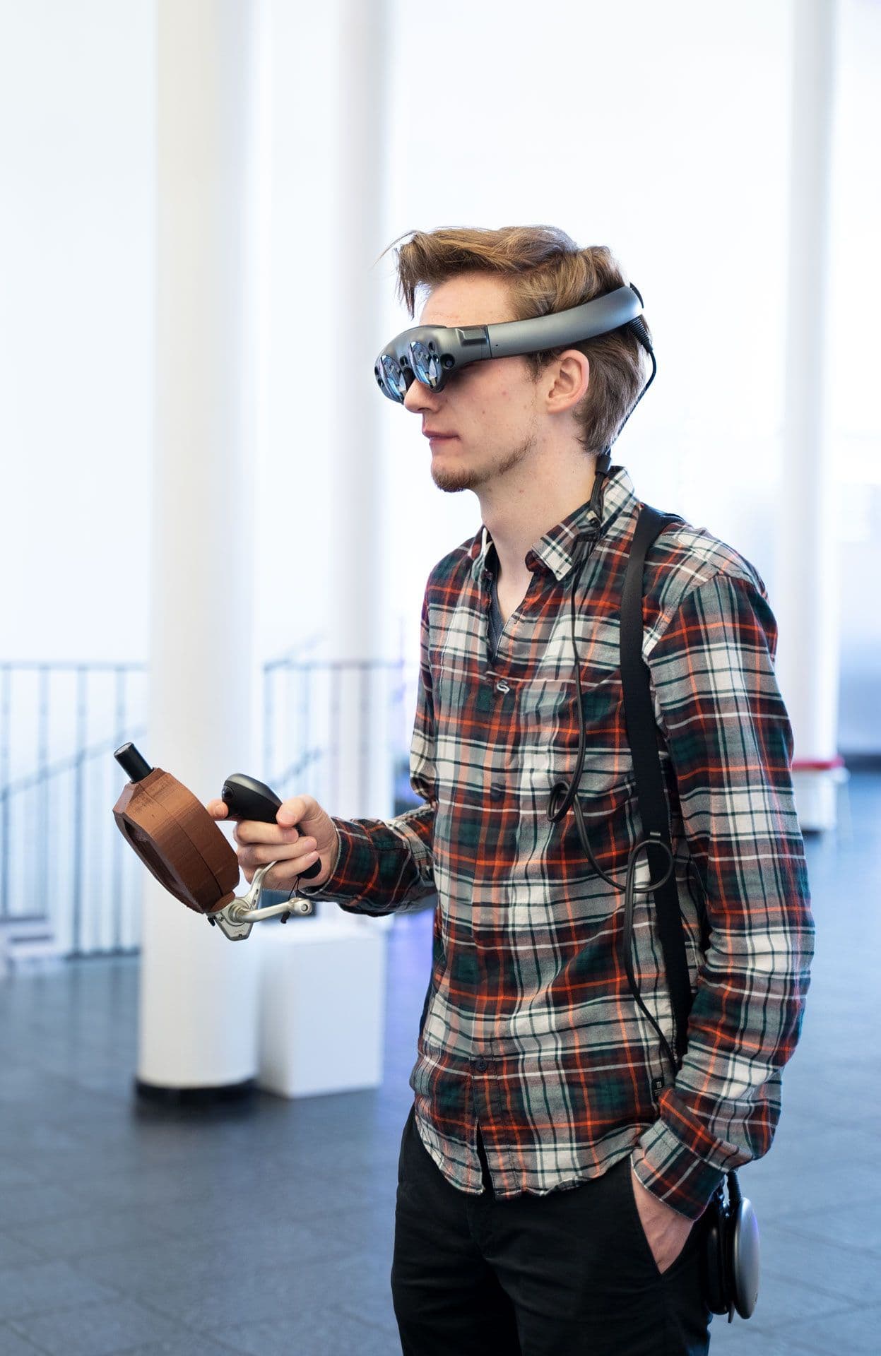 Person fishing with VR goggles and VR fishing rod